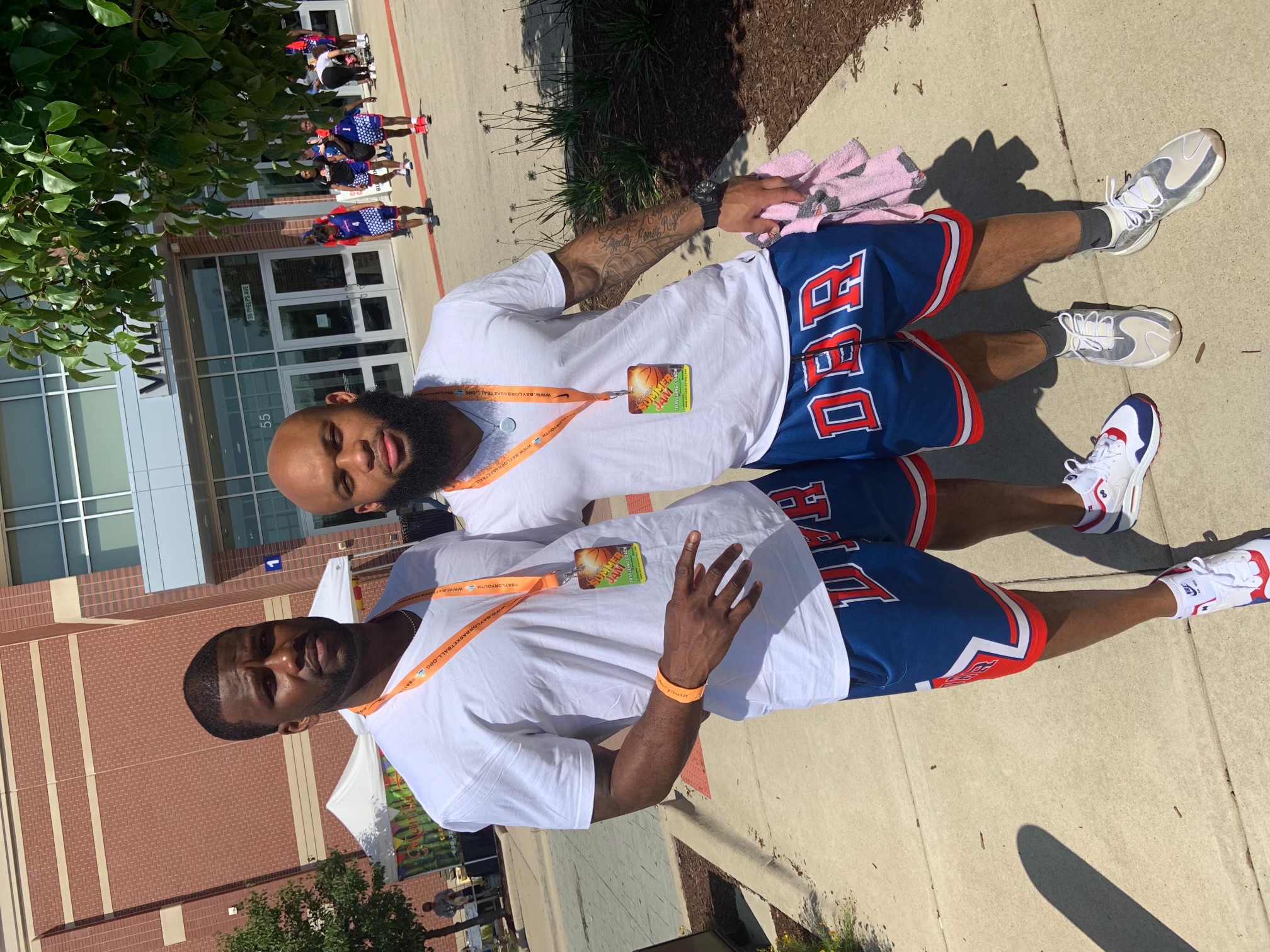 DBR mentors standing outside a basketball event venue