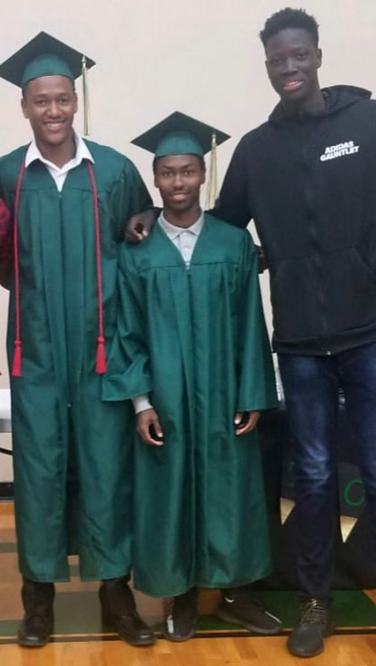 Graduates standing together in caps and gowns