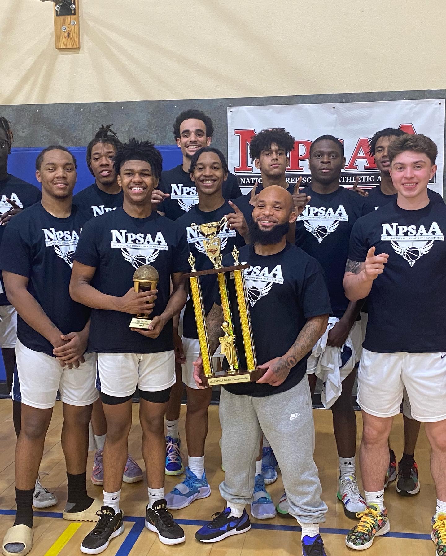 DBR basketball team celebrating with a championship trophy