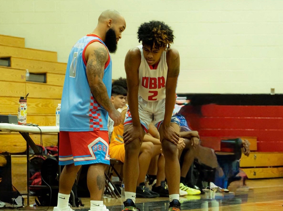 DBR coach mentoring a player during a basketball game