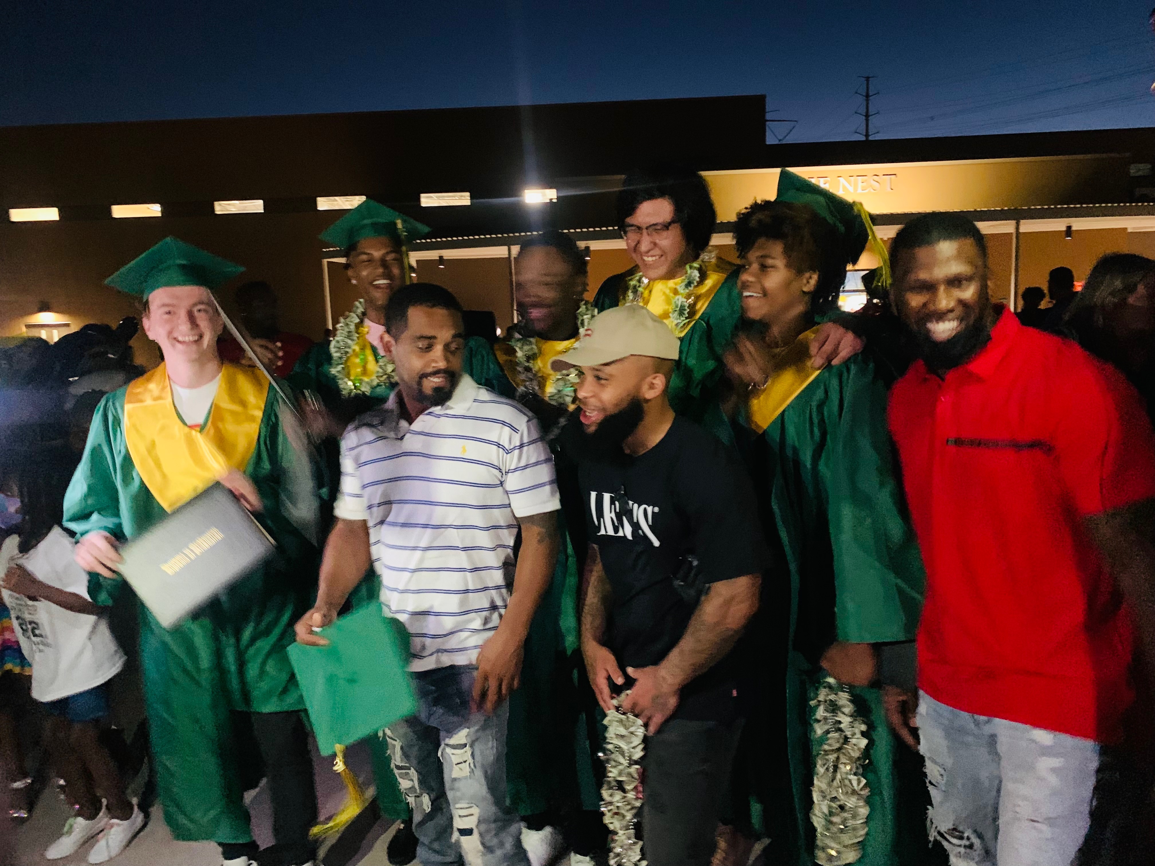 Graduates and mentors celebrating together after graduation